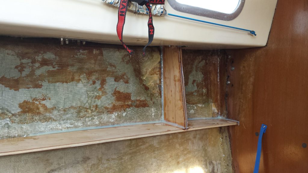 The shelf and chainplate knee is fiberglassed and filleted on out bristol 26 sailboat.